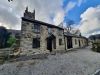Converted listed barn with black windows and doors