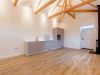 kitchen and vaulted ceiling with timber trusses in converted barn