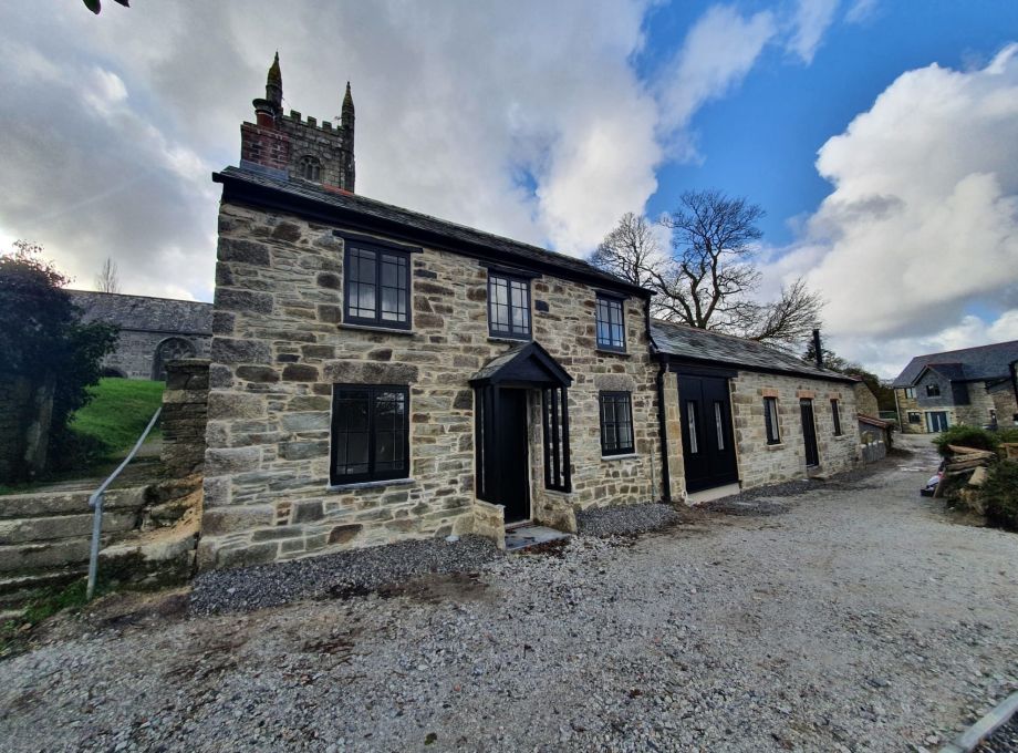 Converted listed barn with black windows and doors